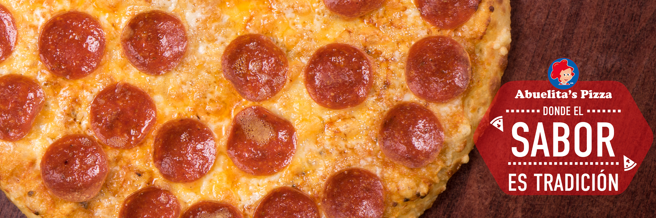 Imagen de una pizza junto a la leyenda: Abuelitas Pizza donde el buen sabor es tradición